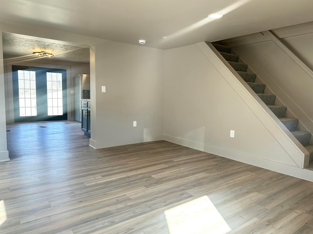 interior space with stairway and light wood-style floors