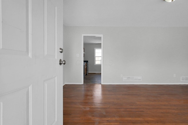 interior space with visible vents, baseboards, and wood finished floors