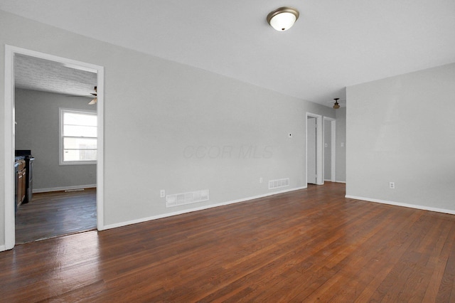 spare room featuring visible vents, baseboards, and hardwood / wood-style flooring