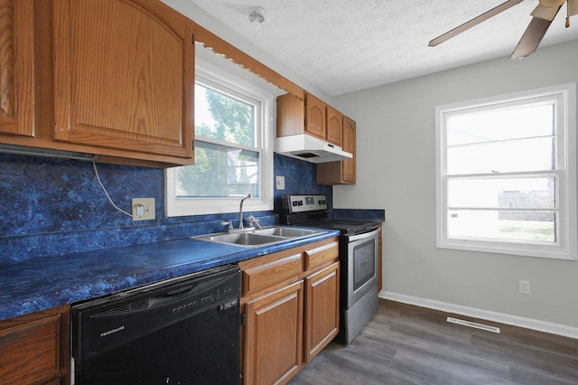 kitchen featuring dark countertops, stainless steel electric range oven, black dishwasher, decorative backsplash, and a sink