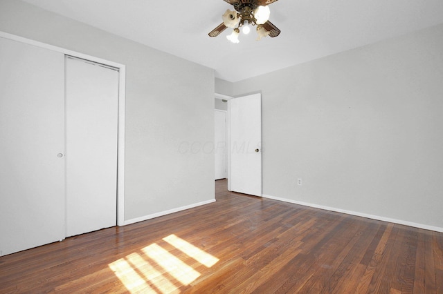 unfurnished bedroom with a closet, baseboards, and wood finished floors