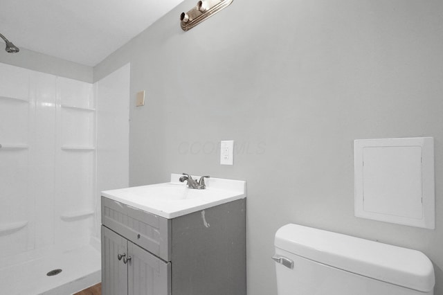 full bath featuring a shower stall, toilet, and vanity