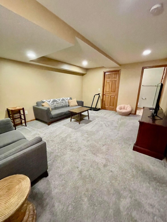 carpeted living room featuring baseboards