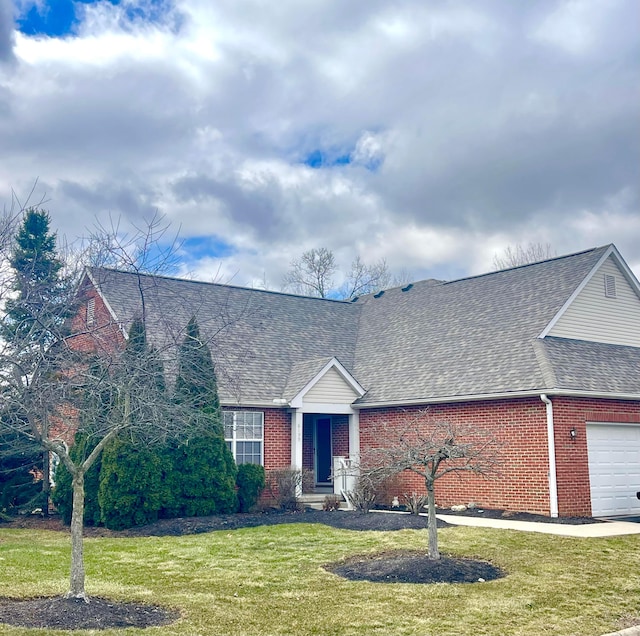 view of front facade with a garage, brick siding, a shingled roof, and a front lawn