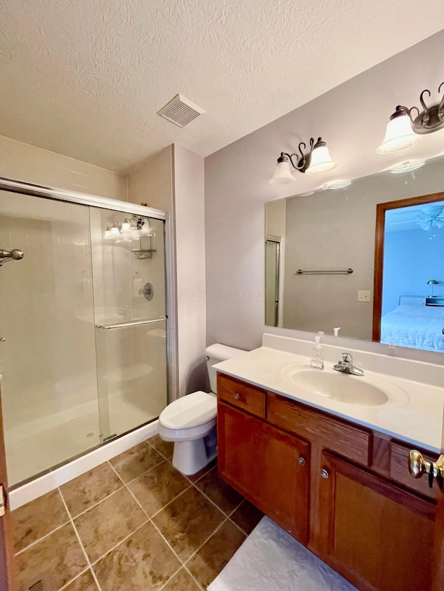 full bath with visible vents, toilet, a shower stall, vanity, and tile patterned floors