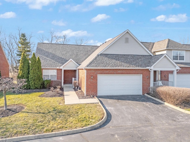 view of front of house with roof with shingles, concrete driveway, an attached garage, a front yard, and brick siding