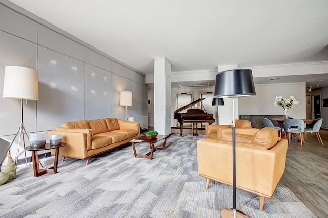 living area featuring light wood-style flooring and crown molding