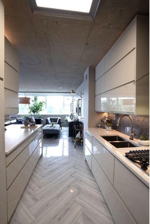 kitchen with light countertops, white cabinetry, a sink, and modern cabinets