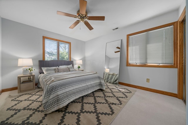 bedroom featuring carpet floors, baseboards, visible vents, and ceiling fan