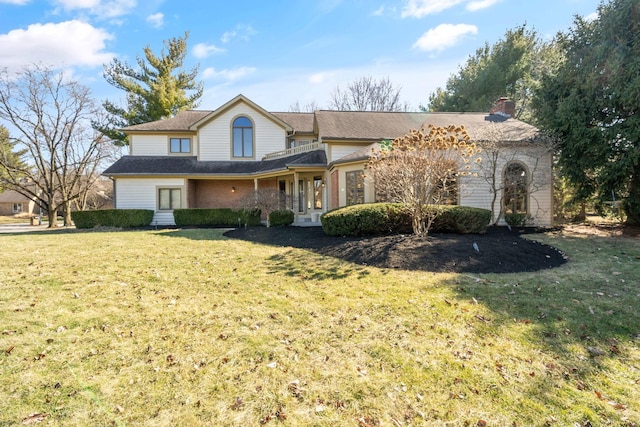 view of front of home featuring a chimney and a front lawn