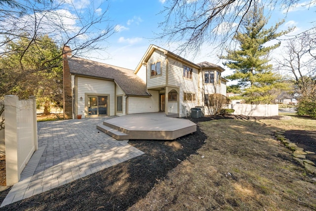 back of house featuring cooling unit and a wooden deck