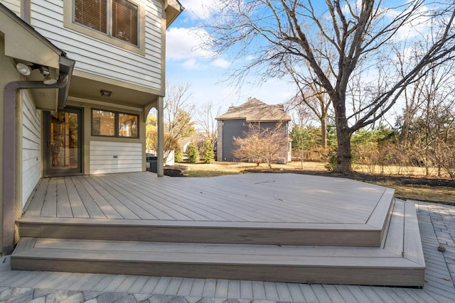 wooden deck featuring an outbuilding