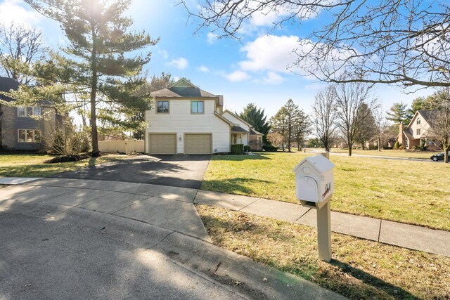 view of home's exterior featuring a garage, driveway, and a yard