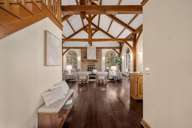 corridor with high vaulted ceiling, beamed ceiling, and dark wood finished floors