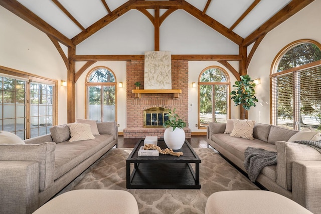 living room featuring a brick fireplace, high vaulted ceiling, wood finished floors, and beamed ceiling