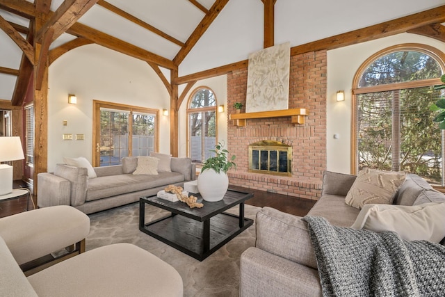 living room featuring high vaulted ceiling, beamed ceiling, a fireplace, and wood finished floors