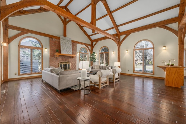 unfurnished living room with dark wood-style floors, a brick fireplace, and a healthy amount of sunlight