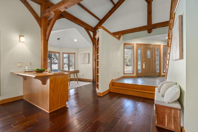 foyer featuring dark wood-style floors, beam ceiling, and baseboards