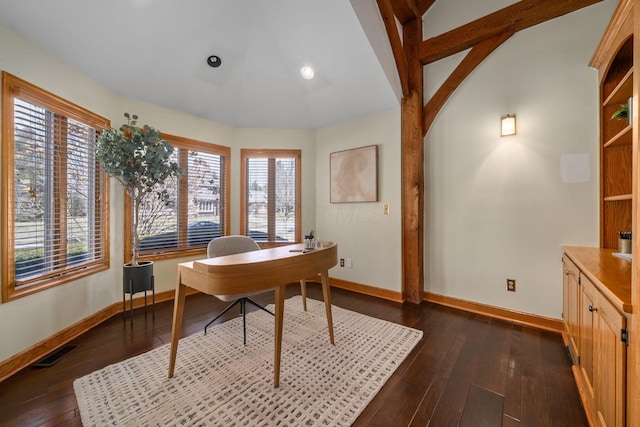 office space with vaulted ceiling with beams, dark wood-style floors, baseboards, and visible vents