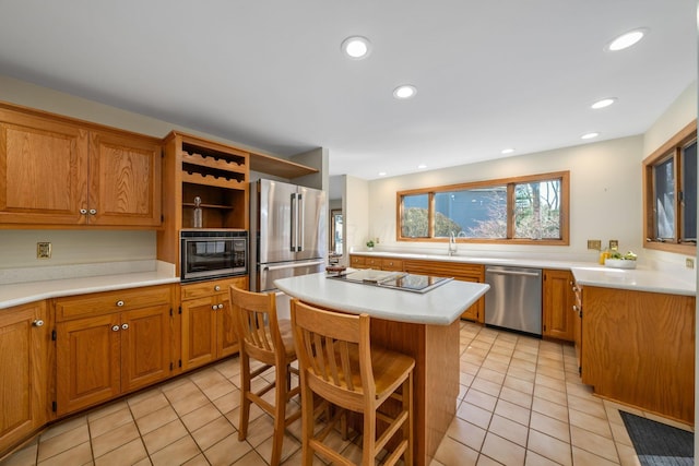 kitchen with stainless steel appliances, a kitchen breakfast bar, light countertops, a center island, and open shelves