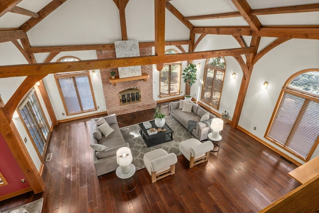 living room with high vaulted ceiling, a wealth of natural light, a fireplace, and hardwood / wood-style flooring