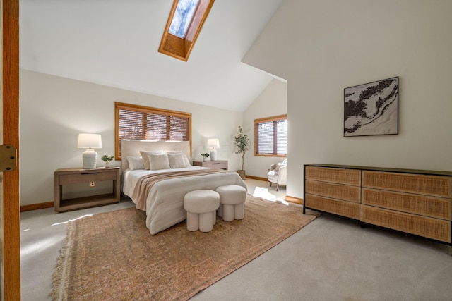 carpeted bedroom featuring high vaulted ceiling, a skylight, and baseboards