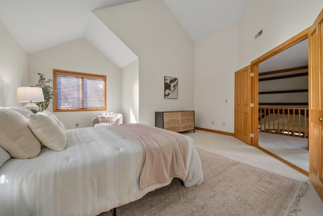 carpeted bedroom with lofted ceiling, visible vents, and baseboards