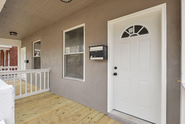 property entrance with stucco siding