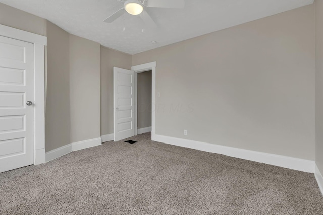 unfurnished bedroom with ceiling fan, carpet floors, and baseboards