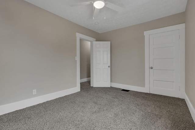 unfurnished room featuring visible vents, baseboards, ceiling fan, a textured ceiling, and carpet floors