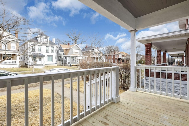 deck with covered porch and a residential view