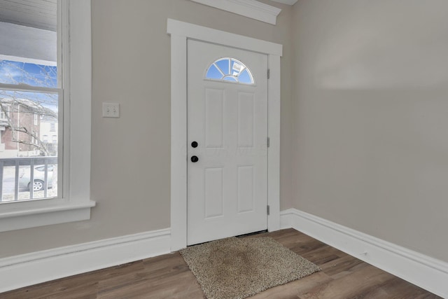 entryway with baseboards and wood finished floors