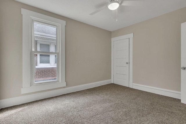 unfurnished room featuring carpet floors, ceiling fan, and baseboards