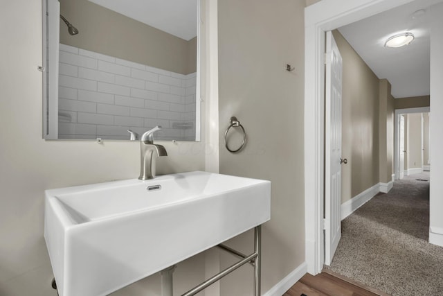 bathroom with a sink and baseboards