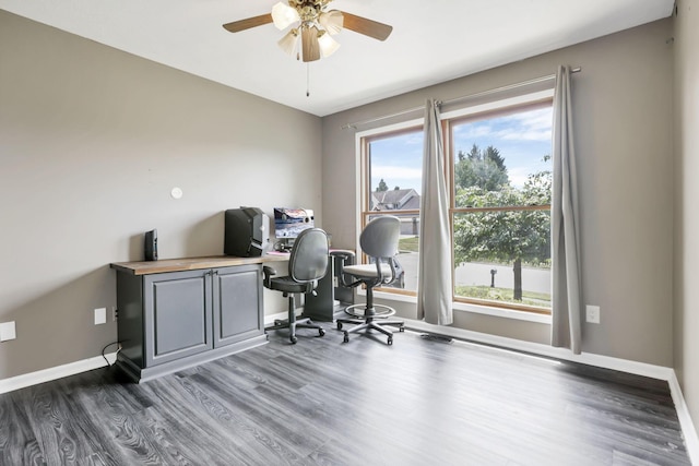 office area featuring a ceiling fan, visible vents, baseboards, and wood finished floors