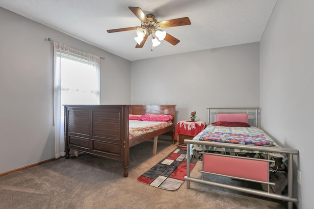 carpeted bedroom with baseboards and a ceiling fan