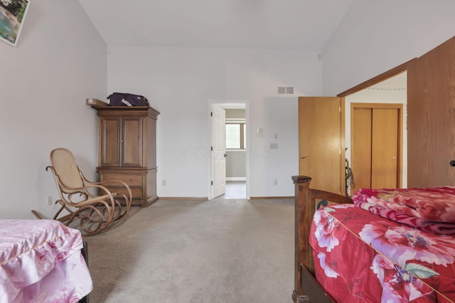 bedroom with carpet, visible vents, lofted ceiling, and baseboards