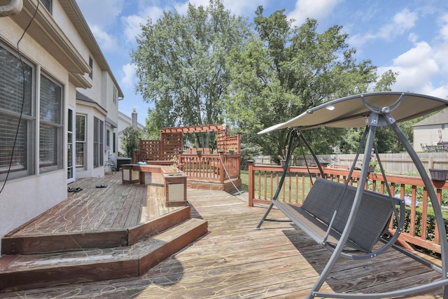 wooden deck with fence and a pergola