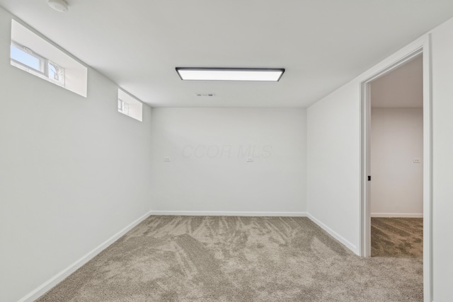 basement with carpet flooring and baseboards