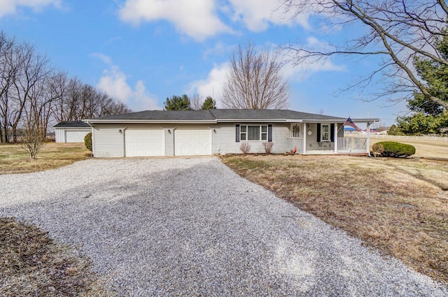 ranch-style home featuring driveway, covered porch, a garage, and a front lawn