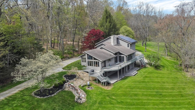 drone / aerial view featuring a wooded view