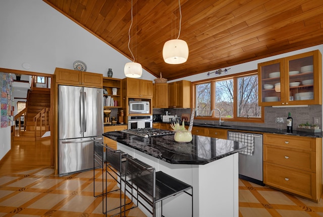 kitchen featuring open shelves, appliances with stainless steel finishes, backsplash, and a sink