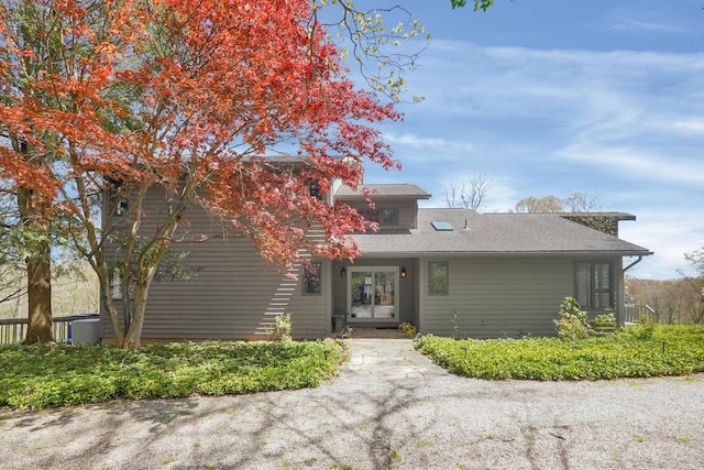 view of front of property featuring roof with shingles