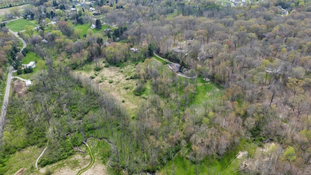 drone / aerial view featuring a wooded view