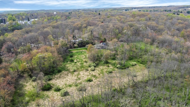 drone / aerial view featuring a wooded view