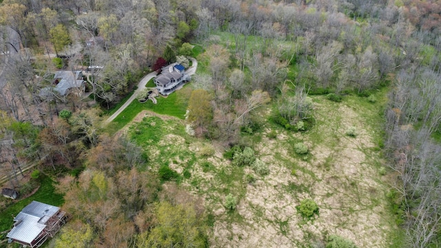 drone / aerial view featuring a wooded view