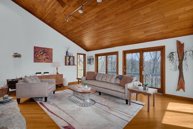 living area with rail lighting, wood ceiling, baseboards, and light wood finished floors