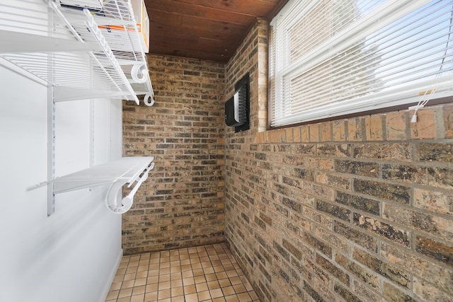 spacious closet with light tile patterned floors