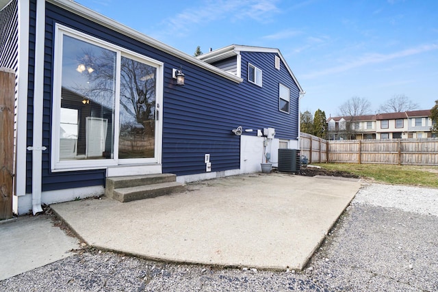 back of house with a patio area, central air condition unit, entry steps, and fence