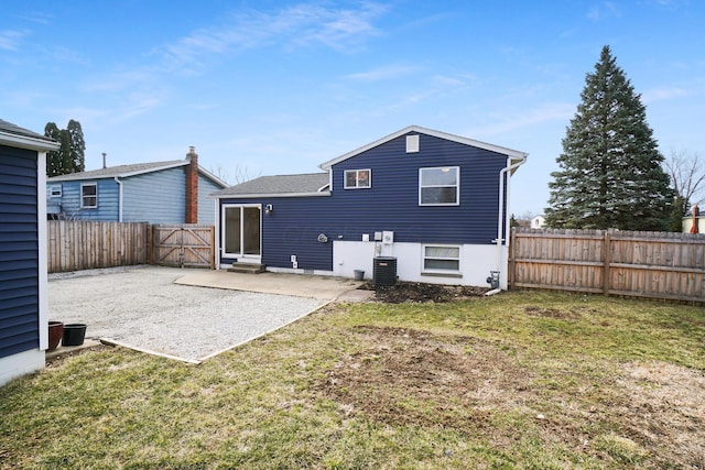 back of property featuring a yard, a fenced backyard, central AC, entry steps, and a patio area